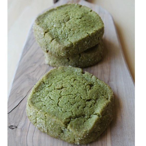 Green cookies on a wooden board.